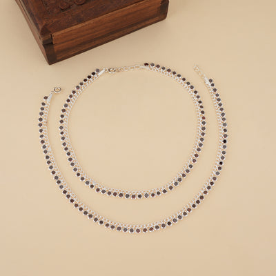 Pair of 925 sterling silver payal with maroon CZ stones set in delicate floral motifs.