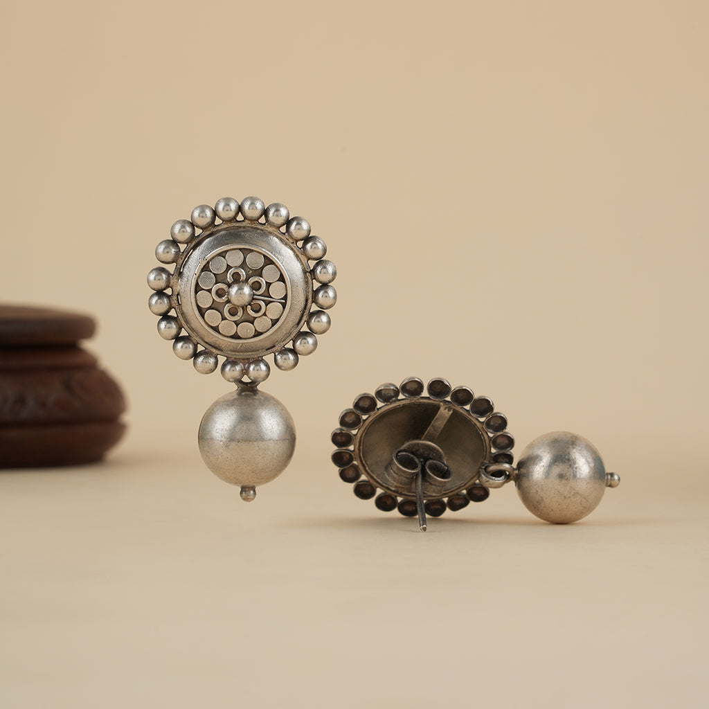 Side view of large sterling silver studs showing detailed dana art and post fastening