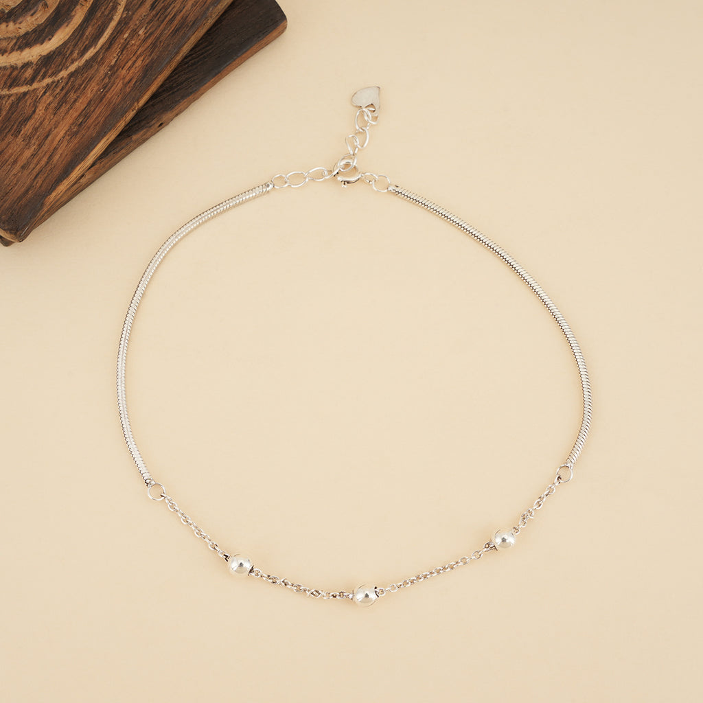925 sterling silver heart charm anklet with delicate chain details and dangling heart charms on a neutral background.