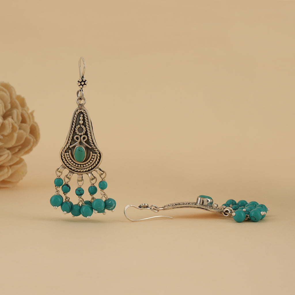 Oxidised silver earrings with intricate detailing and hanging turquoise beads