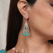 Load image into Gallery viewer, Model wearing Oxidised silver earrings with intricate detailing and hanging turquoise beads